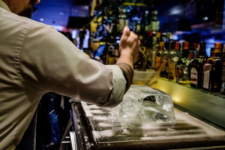 DSCF8066 | Sobou New Orlenas by popular Atlanta travel blog: image of a bar tender picking away at a block of ice. 