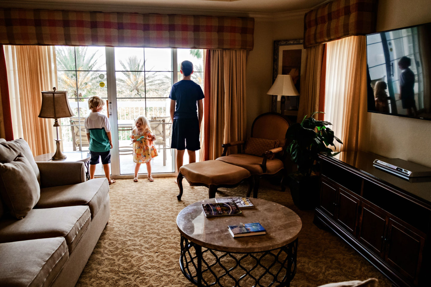 Reunion Resort by popular Atlanta travel blog, Chelissima: image of Chelsea Patricia's children looking out the window of their Reunion Resort room. 