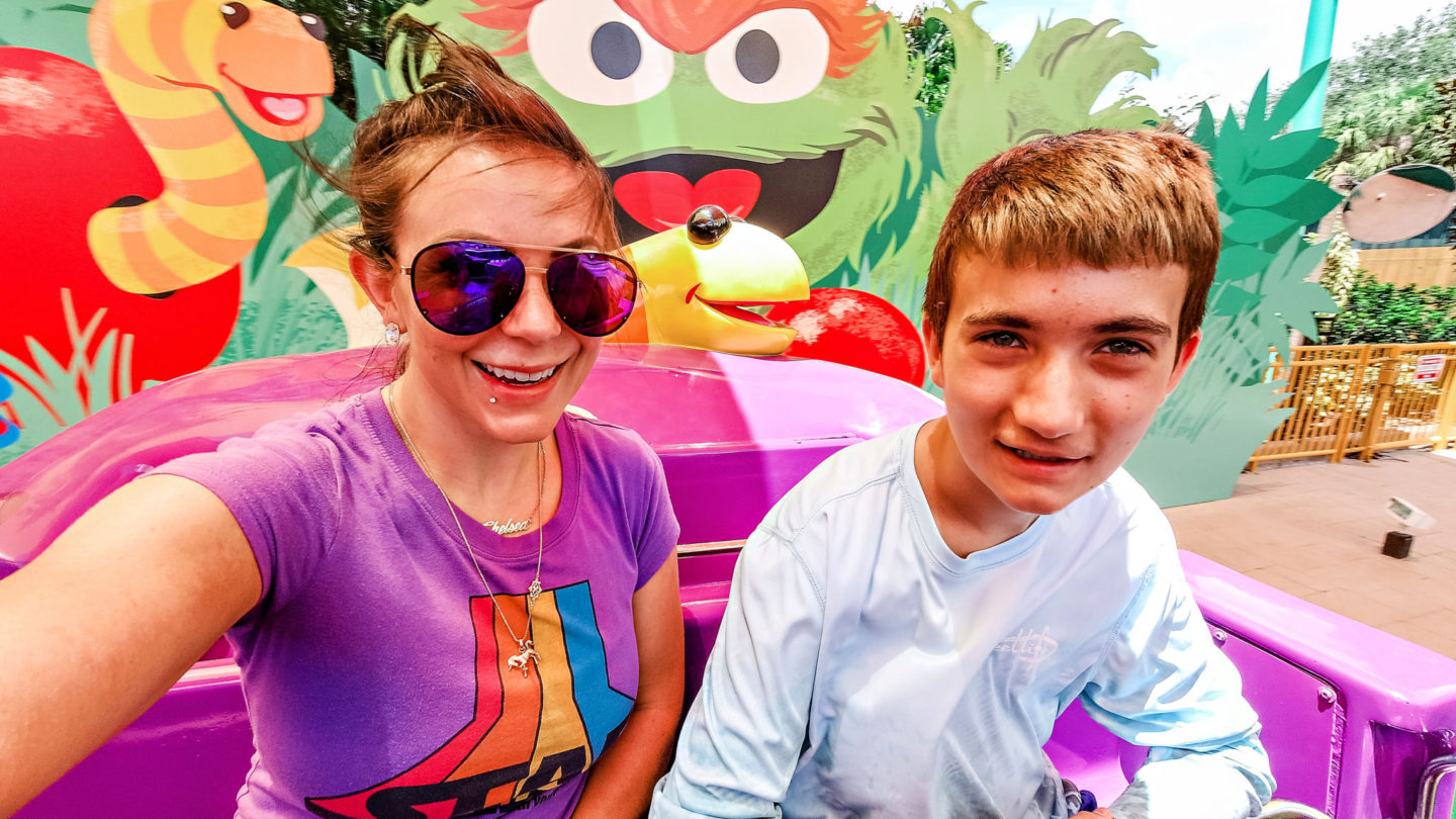 Best Things to Do in Orlando with Teenagers: Visit SeaWorld for Rollercoasters & Sesame Street, featured by top US travel blogger, Chelissima | Things to do in Orlando by popular Atlanta travel blog: image of Chelsea Patricia and her teenage son on the Oscar and Slimy ride. 
